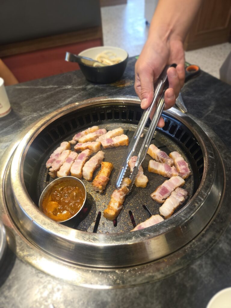 Staff grilling the meat at our table